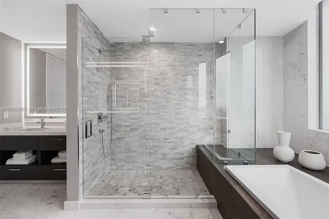 a bathroom with a tub sink and mirror