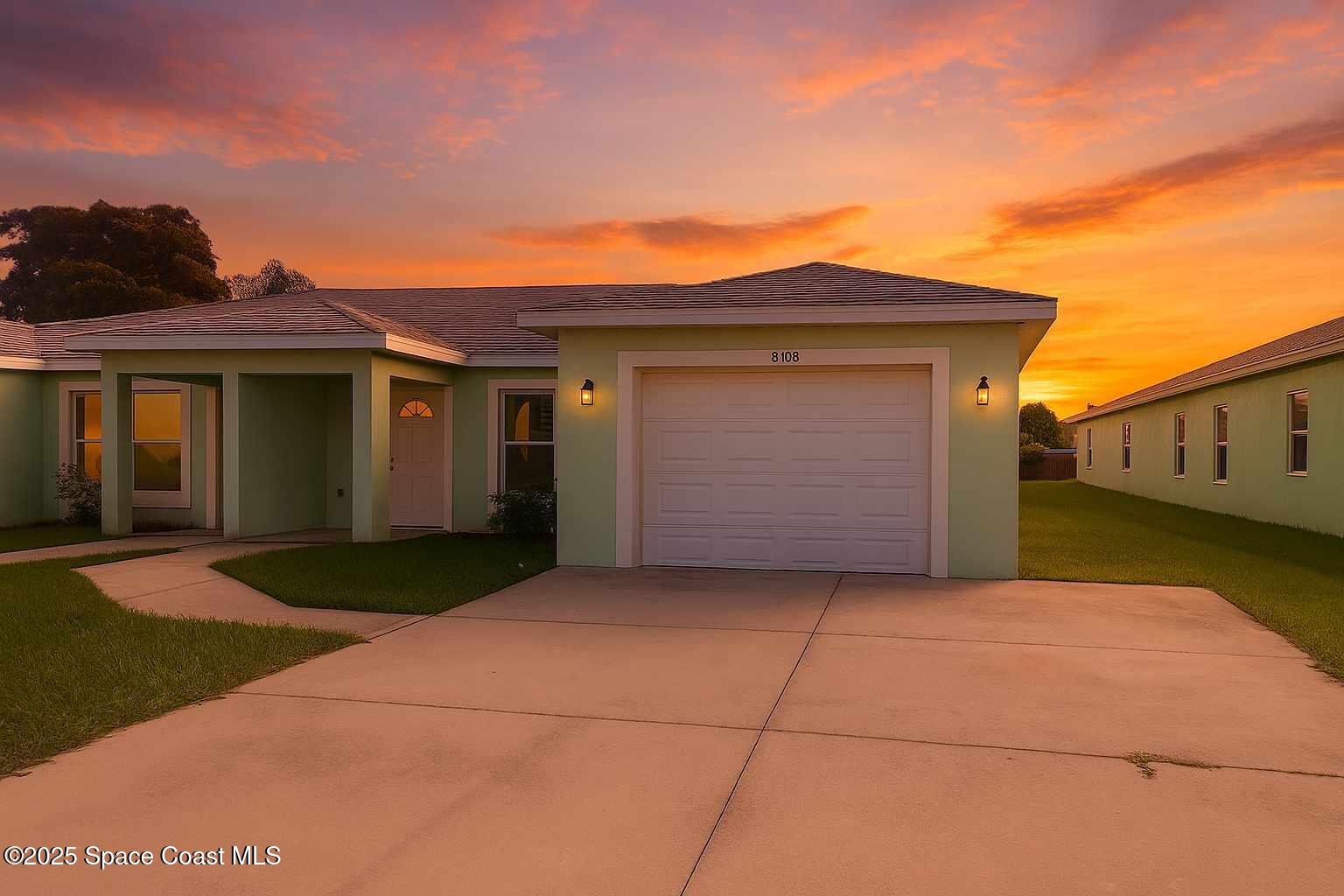 819 Angela Avenue, Unit B Rockledge, FL 32955 - Photo 1 of 11 a front view of a house with a yard and garage