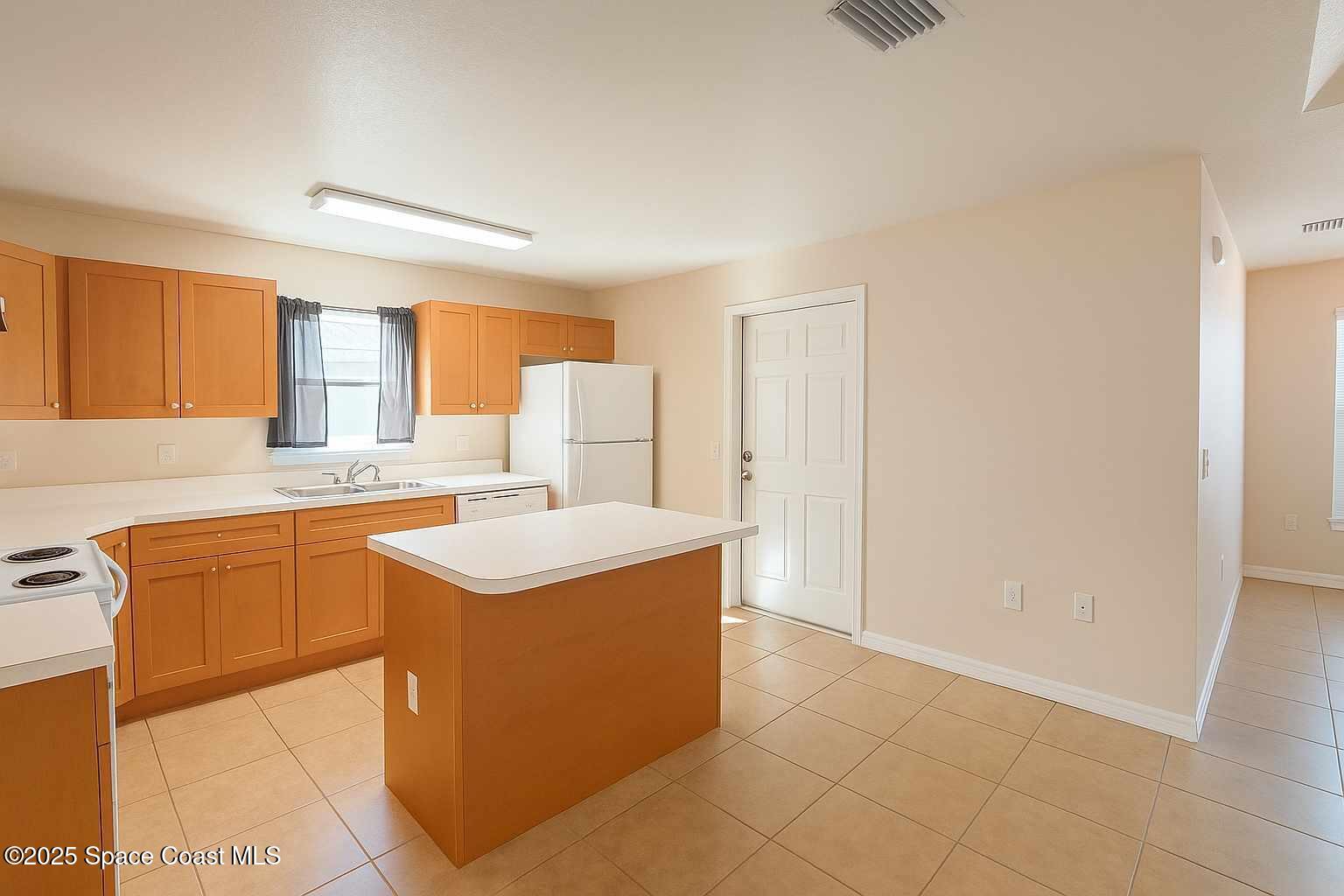 819 Angela Avenue, Unit B Rockledge, FL 32955 - Photo 6 of 11 a kitchen with stainless steel appliances granite countertop a sink and a refrigerator