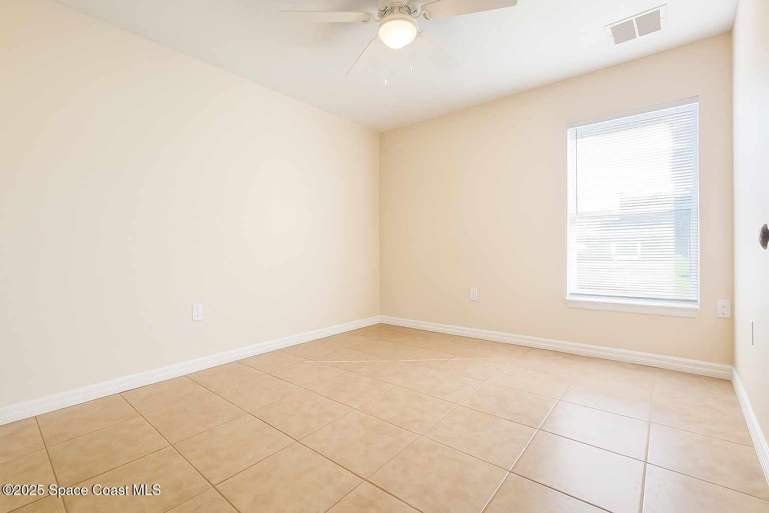 819 Angela Avenue, Unit B Rockledge, FL 32955 - Photo 7 of 11 an empty room with windows