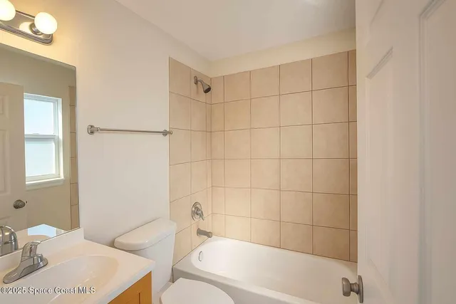 a bathroom with a toilet a sink and a bathtub