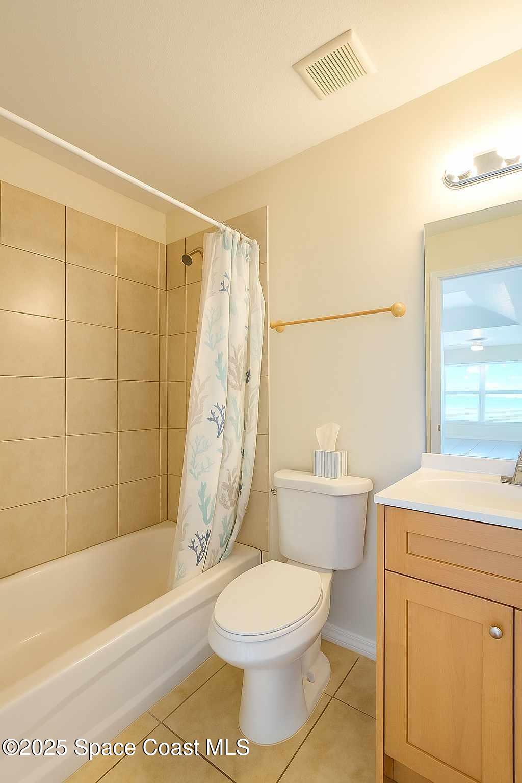 819 Angela Avenue, Unit B Rockledge, FL 32955 - Photo 10 of 11 a bathroom with a toilet a sink and a bathtub