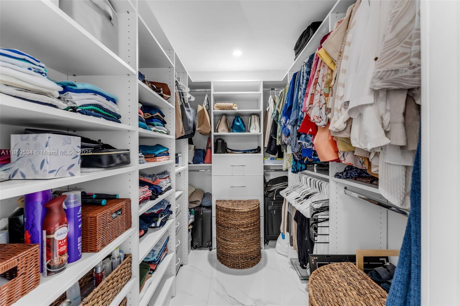 11186 Southwest 75th Terrace Miami, FL 33173 - Photo 13 of 26 a view of walk in closet with clothes and shoes