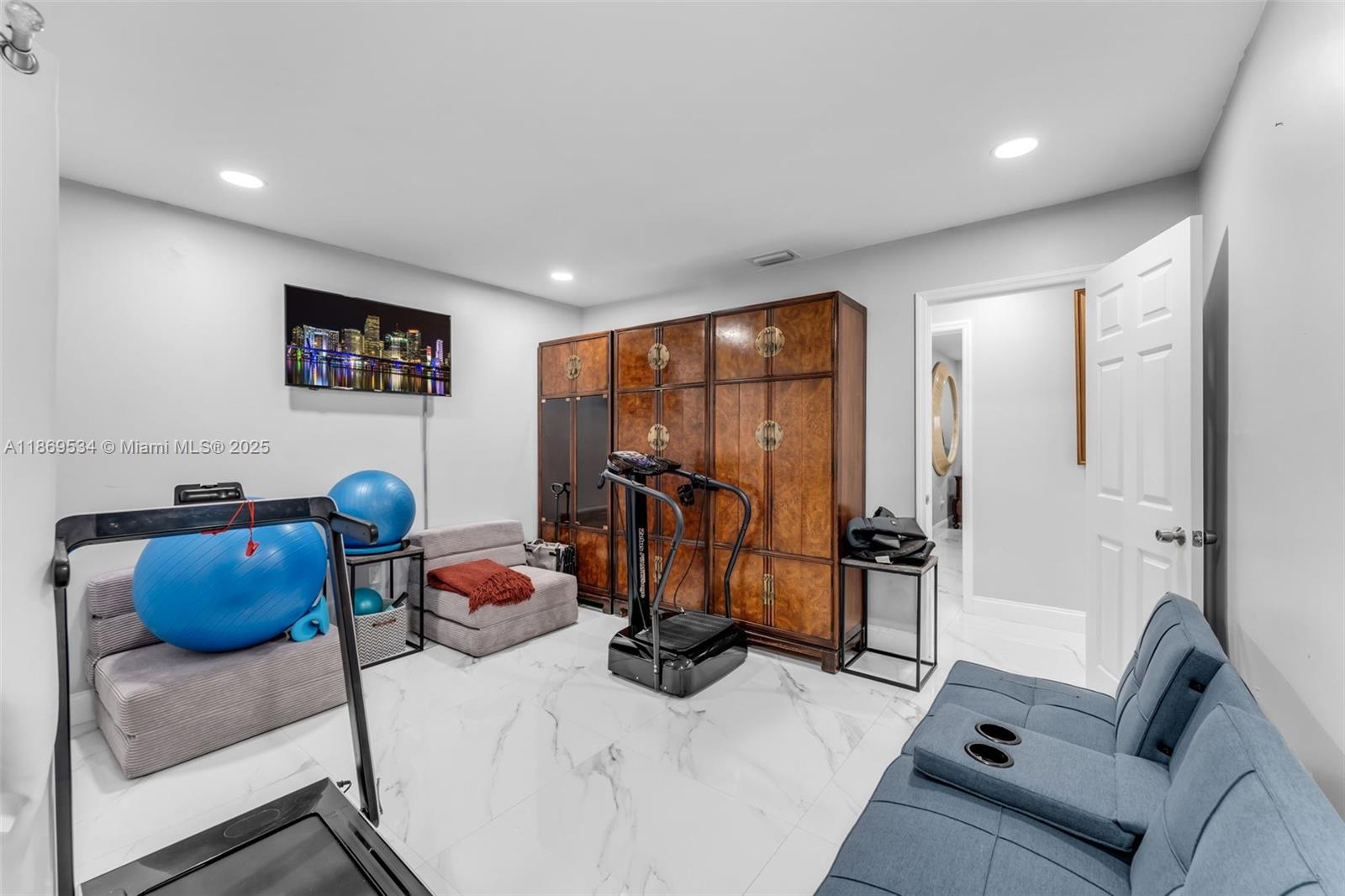 11186 Southwest 75th Terrace Miami, FL 33173 - Photo 14 of 26 a bedroom with furniture a flat screen tv and a window