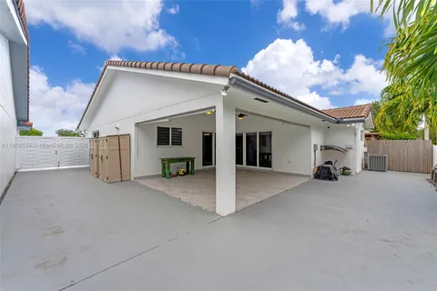 a view of a house with couches and backyard