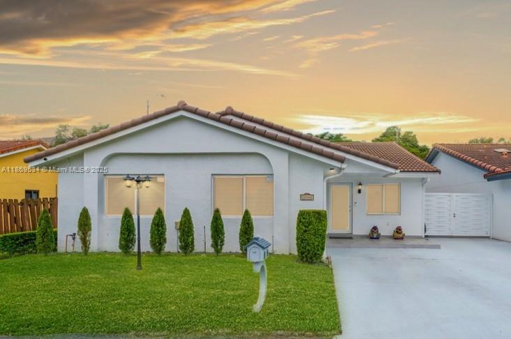 11186 Southwest 75th Terrace Miami, FL 33173 - Photo 2 of 26 a view of a white house with a big yard and potted plants