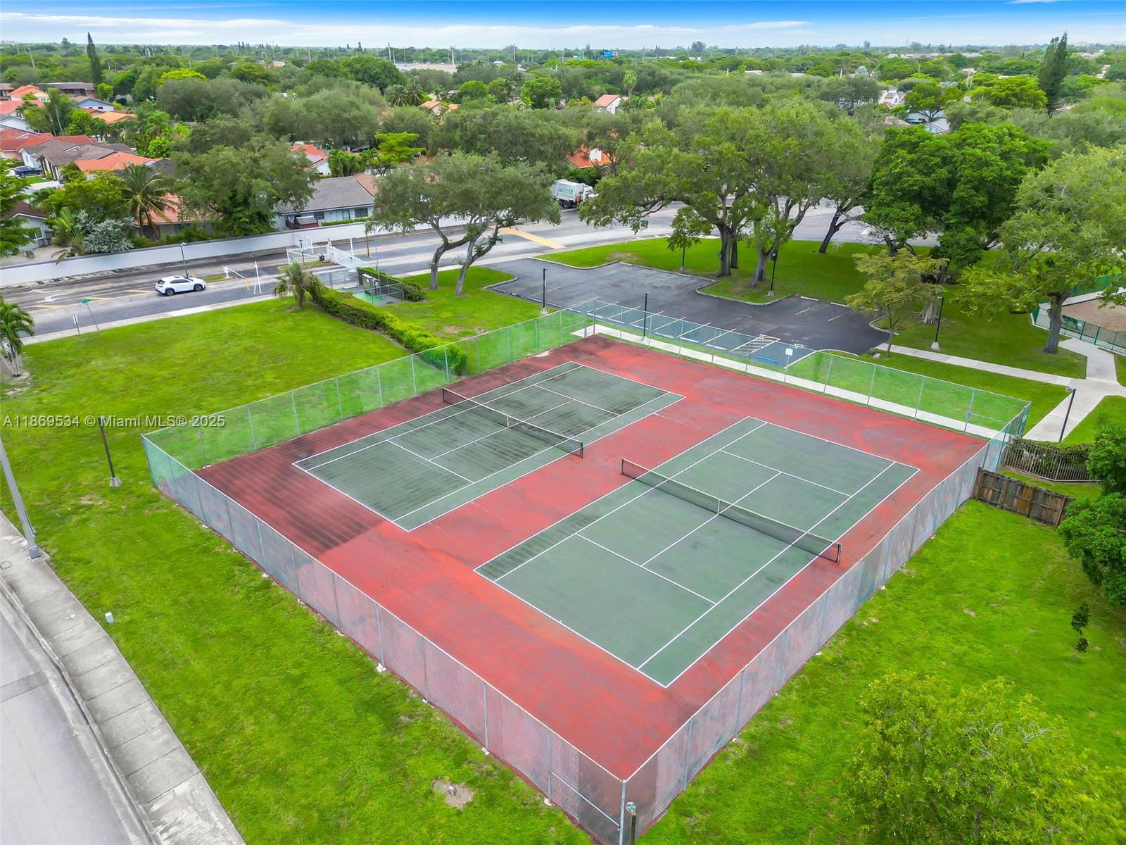 11186 Southwest 75th Terrace Miami, FL 33173 - Photo 24 of 26 an aerial view of a tennis ground and a cars park