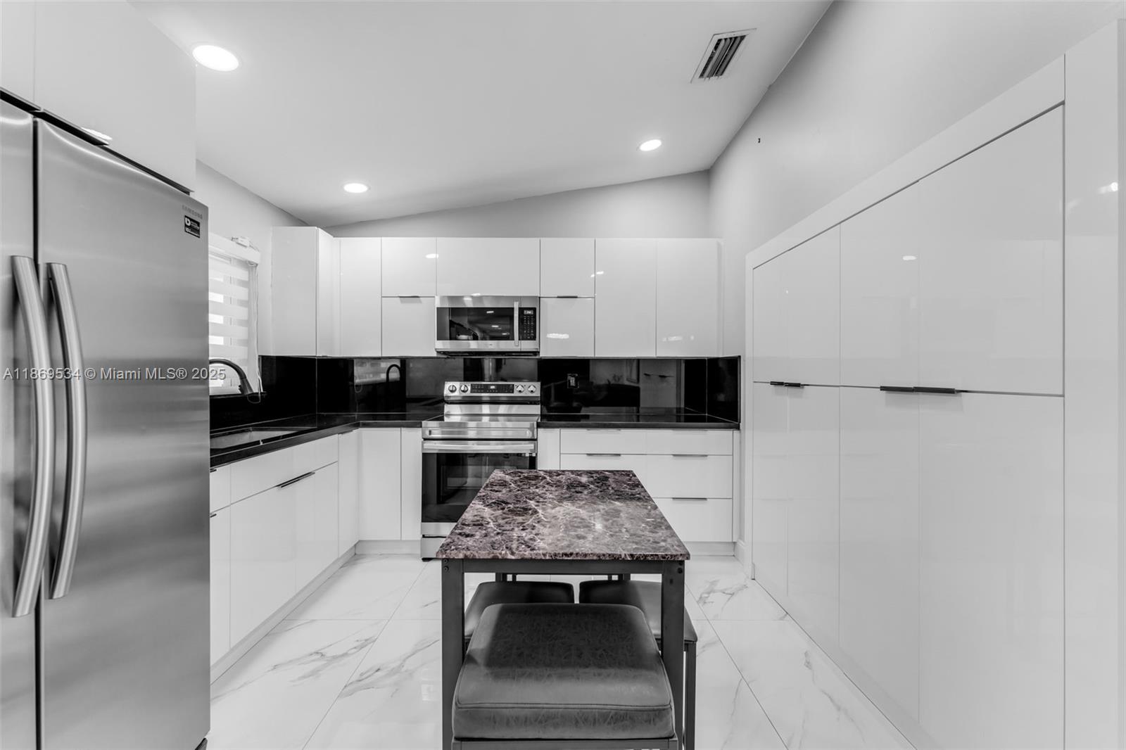 11186 Southwest 75th Terrace Miami, FL 33173 - Photo 4 of 26 a kitchen with stainless steel appliances a refrigerator stove microwave and sink