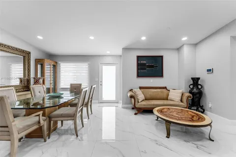 a living room with furniture a rug and a large window