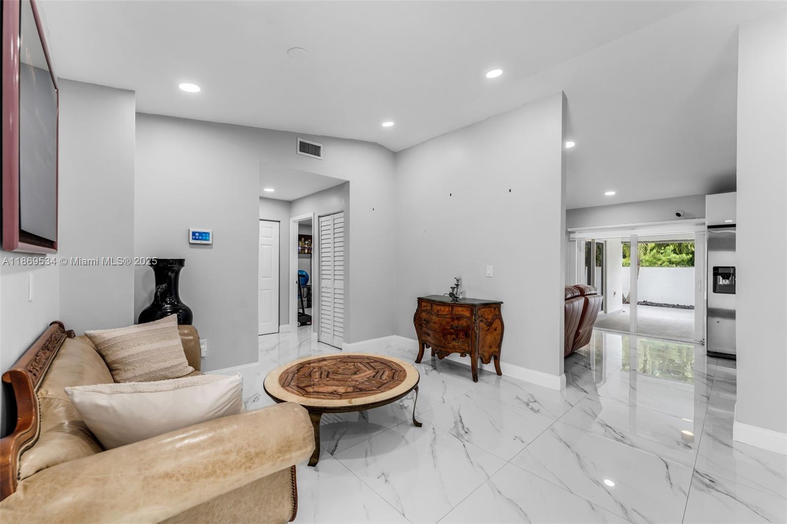 11186 Southwest 75th Terrace Miami, FL 33173 - Photo 6 of 26 a living room with furniture and a table