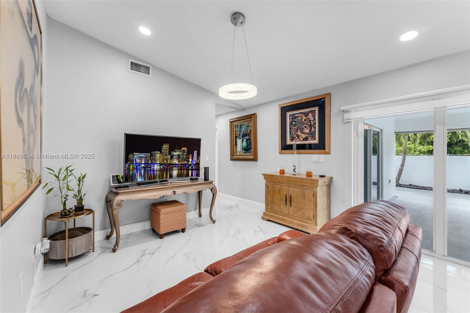 11186 Southwest 75th Terrace Miami, FL 33173 - Photo 7 of 26 a living room with furniture and a flat screen tv