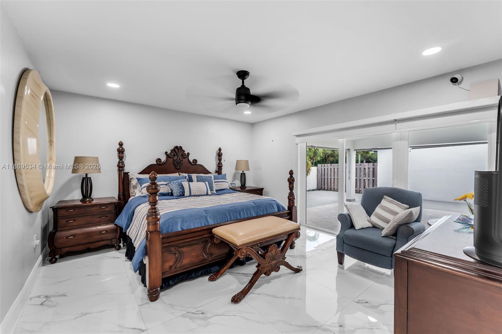 11186 Southwest 75th Terrace Miami, FL 33173 - Photo 9 of 26 a bedroom with bed and a chandelier