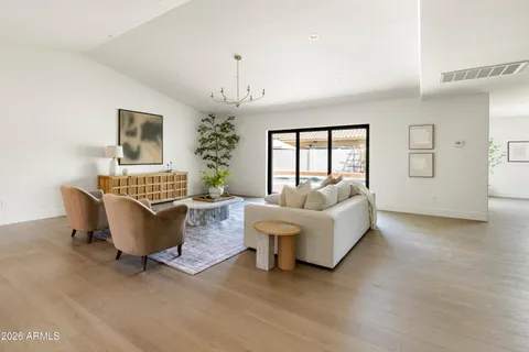 a living room with furniture and view of kitchen