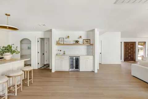 a kitchen with stainless steel appliances kitchen island granite countertop a sink and a refrigerator