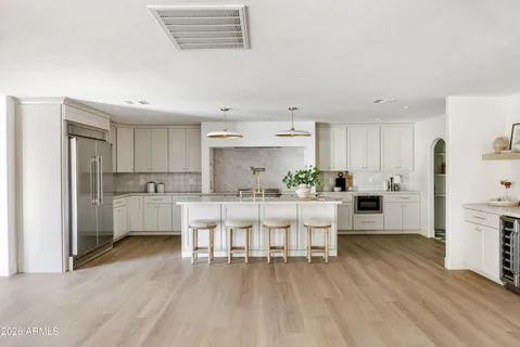 a kitchen with stainless steel appliances and white cabinets