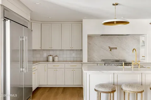 a living room with furniture and kitchen view