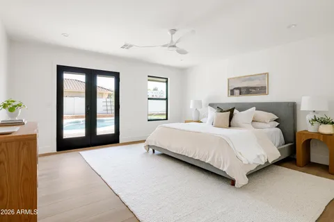 an empty room with a window and a ceiling fan