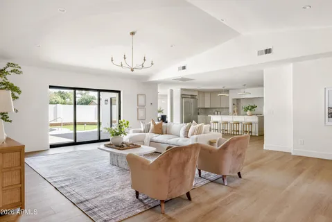 a living room with furniture and a chandelier