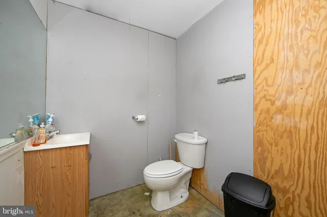 a bathroom with a toilet a sink and mirror