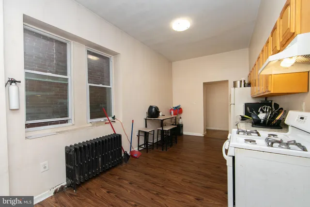 a kitchen with stainless steel appliances granite countertop a refrigerator a stove a sink and a microwave