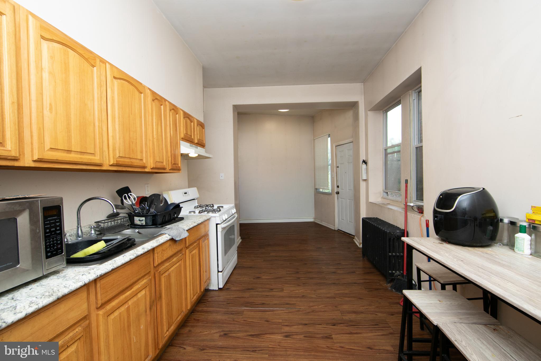 1574 Mt Ephraim Avenue Camden, NJ 08104 - Photo 31 of 54 a kitchen with stainless steel appliances granite countertop a stove a sink and a refrigerator