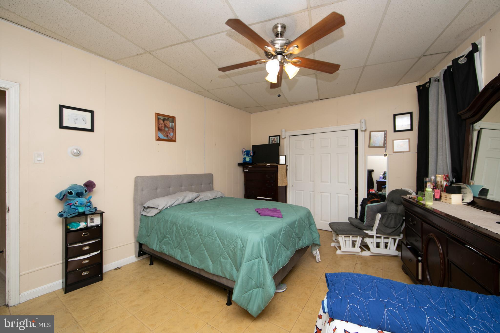 1574 Mt Ephraim Avenue Camden, NJ 08104 - Photo 41 of 54 a bedroom with a bed dresser and a flat screen tv