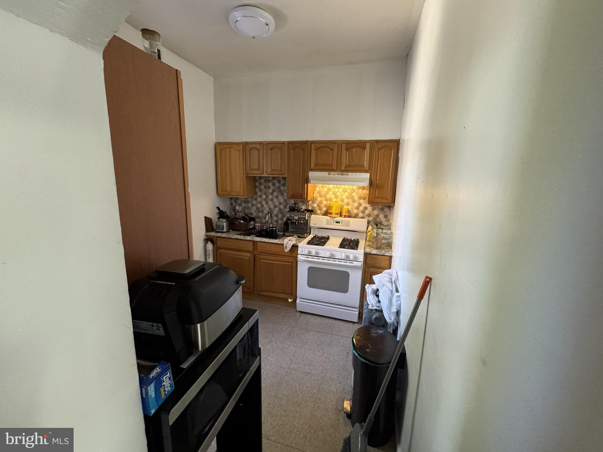1574 Mt Ephraim Avenue Camden, NJ 08104 - Photo 53 of 54 a kitchen with a refrigerator and a stove