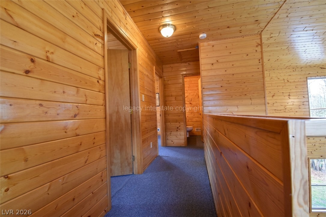 1129 East Ponderosa Road Hatch, UT 84735 - Photo 23 of 47 Warm timber paneling wraps this upper-level hallway overlooking the living area below.