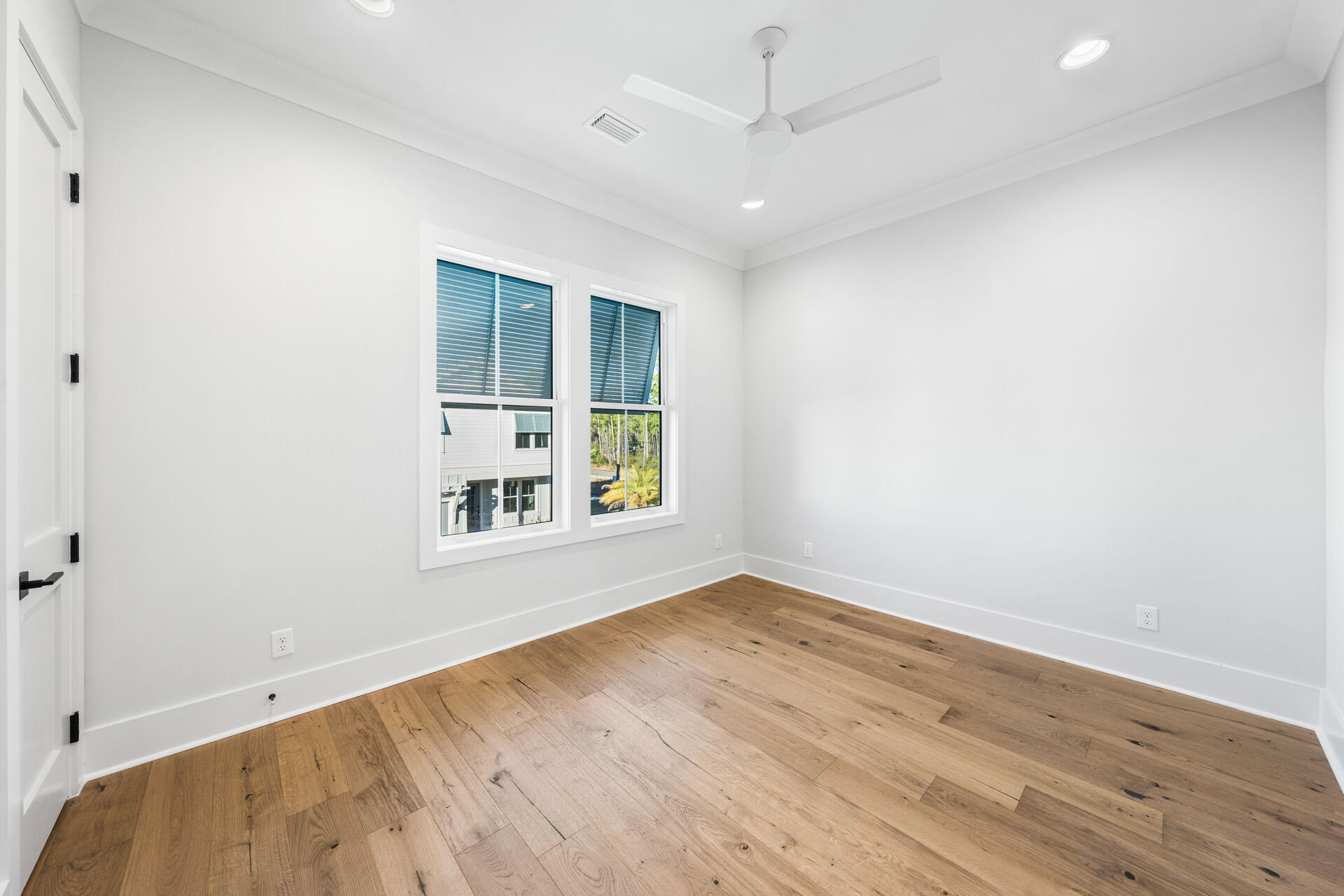 520 South County Highway 393, Unit 39B Santa Rosa Beach, FL 32459 - Photo 26 of 45 an empty room with wooden floor and windows