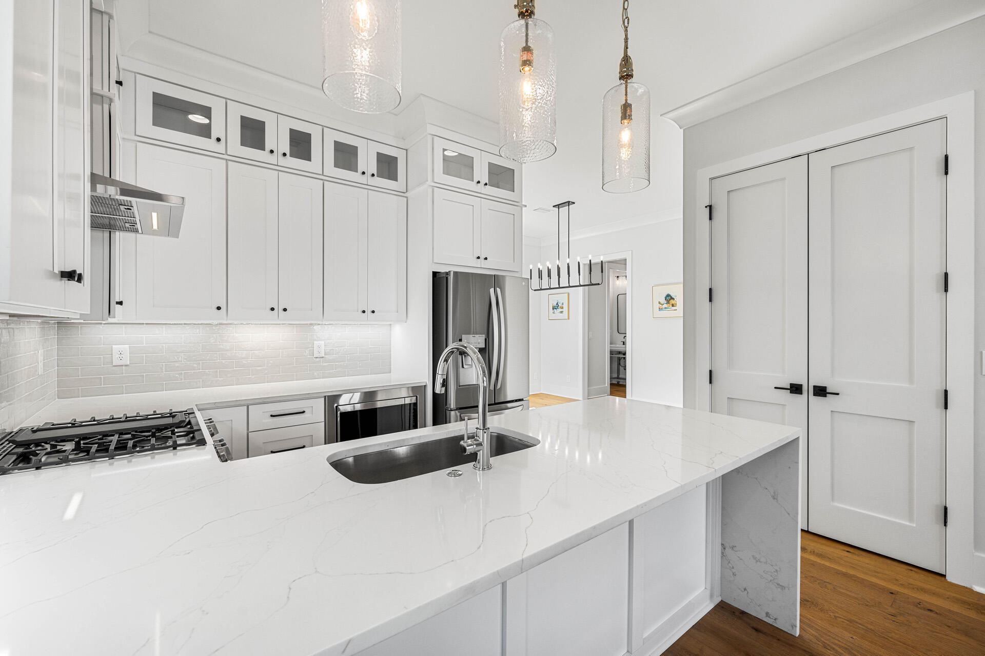 520 South County Highway 393, Unit 39B Santa Rosa Beach, FL 32459 - Photo 5 of 45 a kitchen with stainless steel appliances granite countertop a refrigerator a sink dishwasher and white cabinets with wooden floor