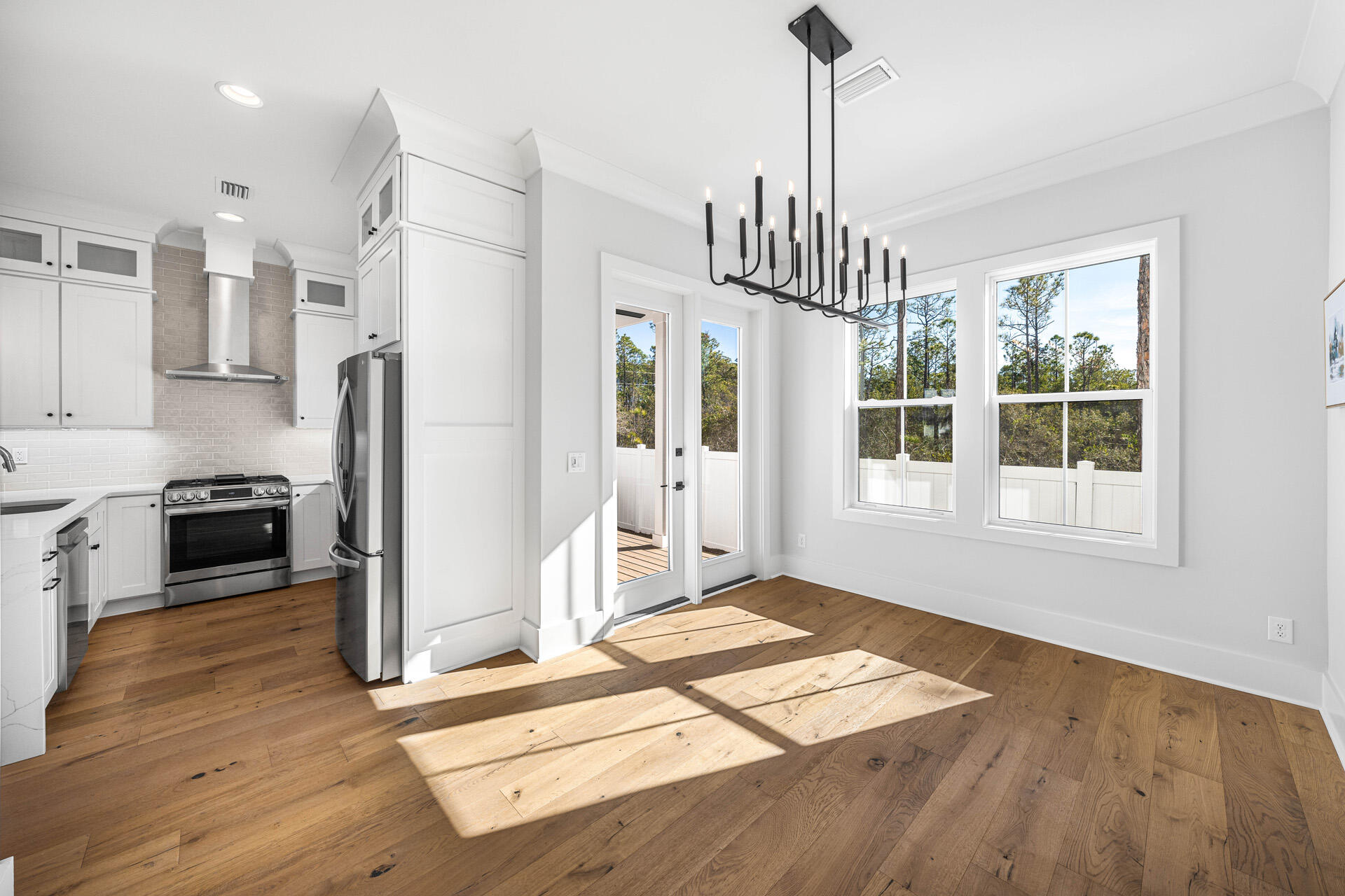 520 South County Highway 393, Unit 39B Santa Rosa Beach, FL 32459 - Photo 9 of 45 a view of a kitchen with wooden floor and a window
