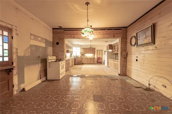 a view of a kitchen with refrigerator and windows