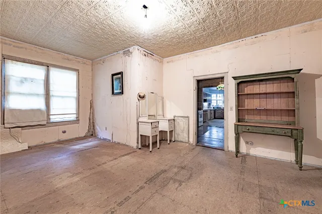 a view of a livingroom with entryway and a window