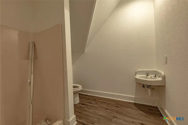 a view of a small space with wooden floor