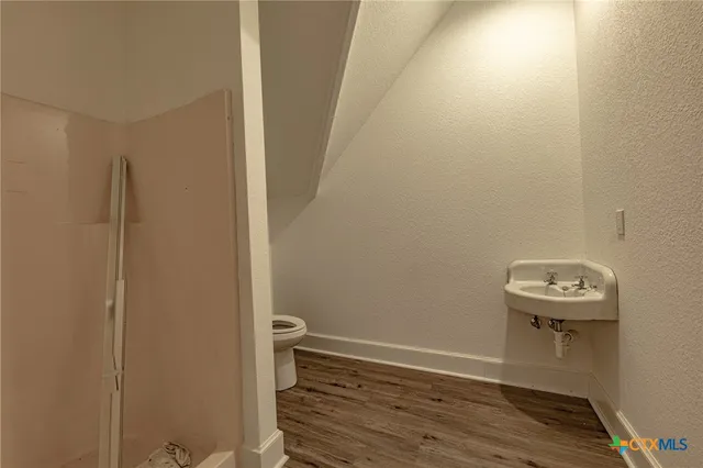 a view of a small space with wooden floor