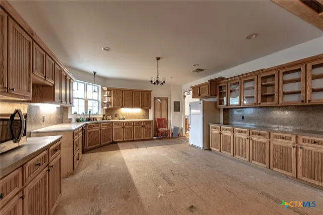 a kitchen with stainless steel appliances kitchen island granite countertop a sink and cabinets