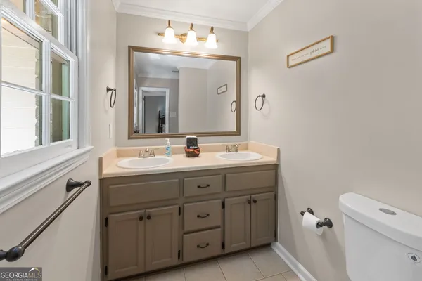 a bathroom with a double vanity sink and a mirror