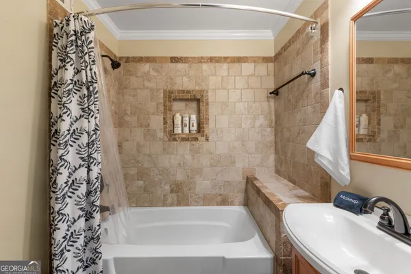 a bathroom with a shower curtain and a sink