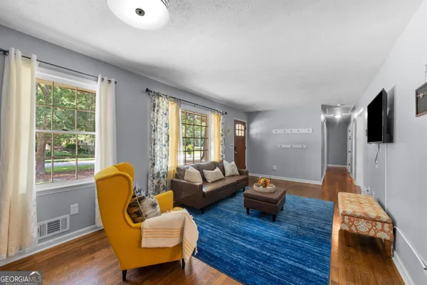 a living room with furniture and a flat screen tv