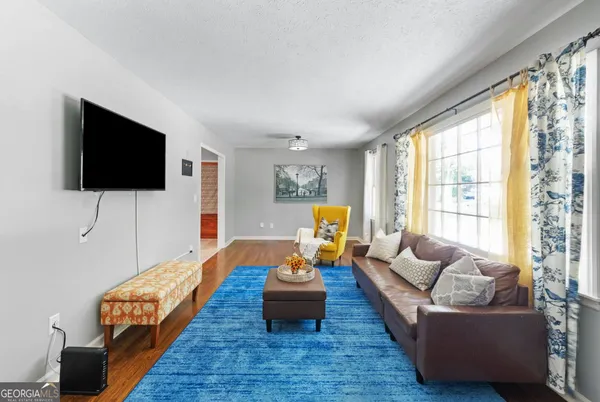 a living room with furniture and a flat screen tv