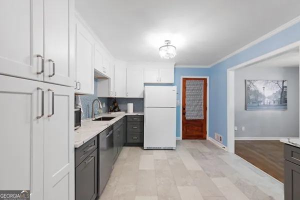 a kitchen with a refrigerator and a sink