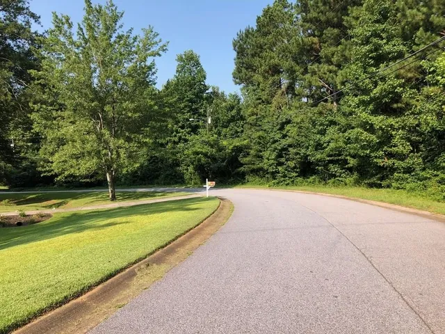 a view of a swimming pool and trees in the background