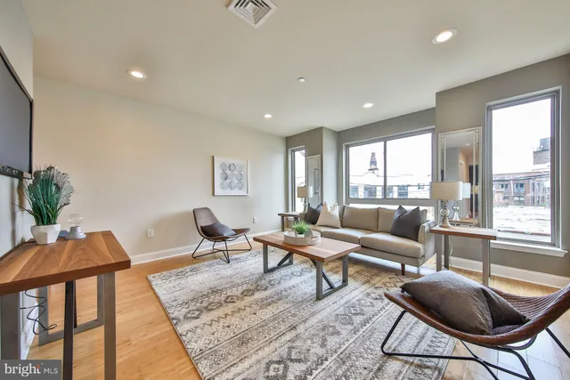 a living room with furniture and a wooden floor