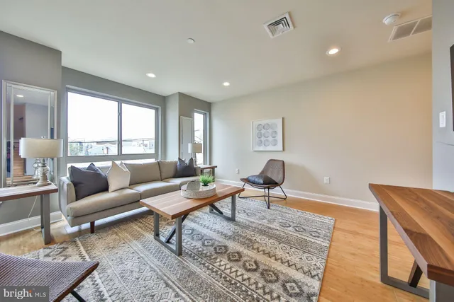 a living room with furniture and a rug
