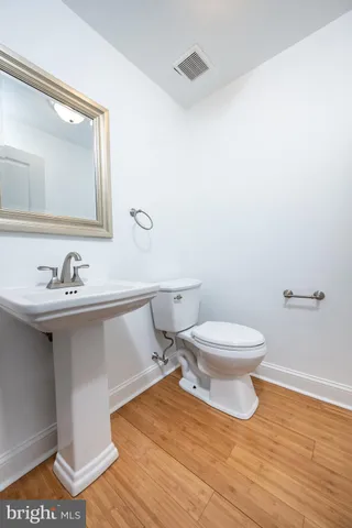 a bathroom with a sink mirror and toilet