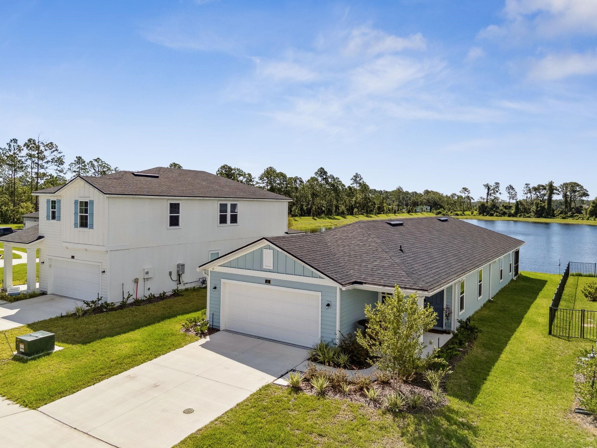 an aerial view of a house with a garden and a yard