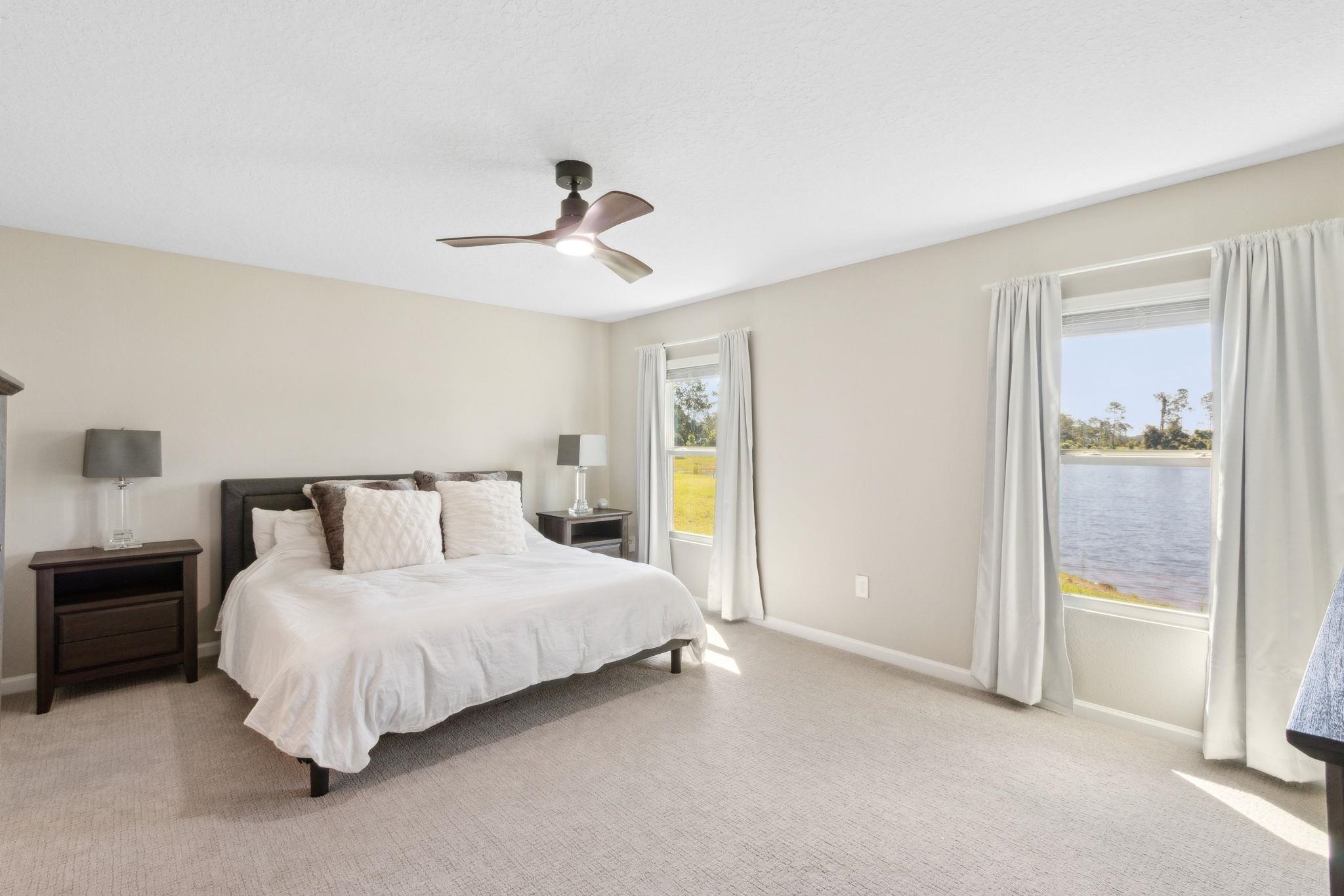 52 Carlota Way St. Augustine, FL 32095 - Photo 12 of 19 a bed room with a bed and a chandelier