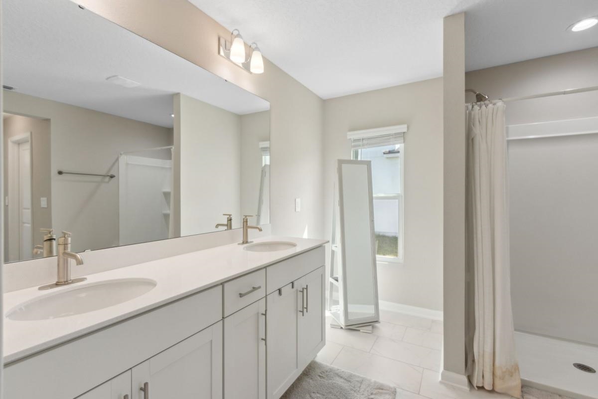 52 Carlota Way St. Augustine, FL 32095 - Photo 13 of 19 a bathroom with a double vanity sink mirror and next to a window