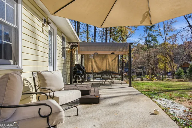 an outdoor view of swimming pool and lounge chair