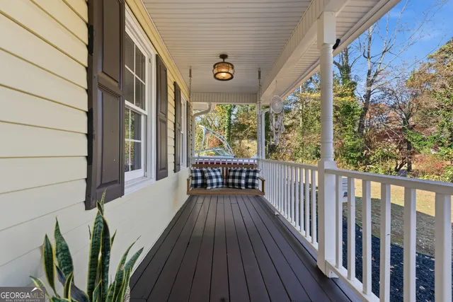a living room with furniture a mirror and a clock